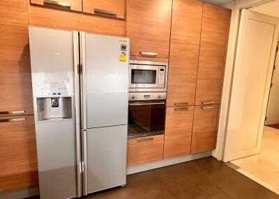 Modern kitchen with wooden cabinets and stainless steel appliances