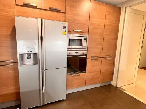 Modern kitchen with wooden cabinets and stainless steel appliances