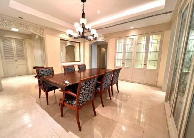 Elegant dining room with wooden dining table and patterned chairs