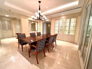 Elegant dining room with wooden dining table and patterned chairs