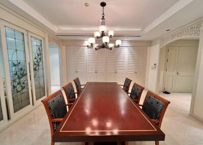 Elegant dining room with a large wooden table and cushioned chairs