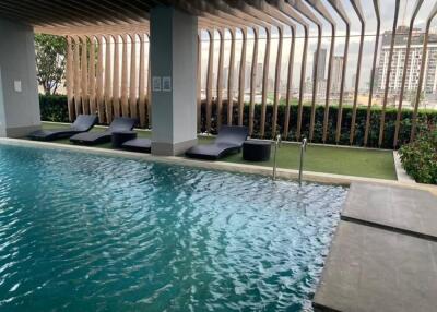 Outdoor pool area with lounge chairs and modern design