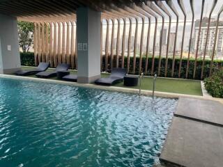 Outdoor pool area with lounge chairs and modern design