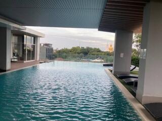 Outdoor infinity pool with a scenic city view