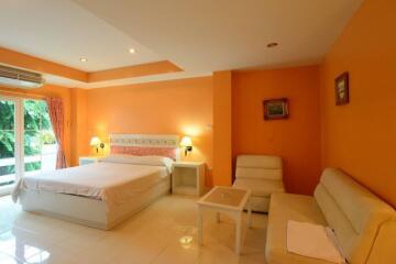 Spacious bedroom with double bed and seating area