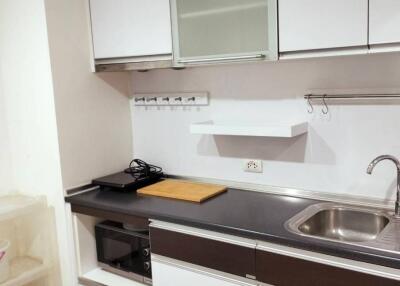 Modern kitchen with white cabinets and stainless steel appliances