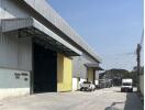 Exterior view of industrial warehouse with parking area