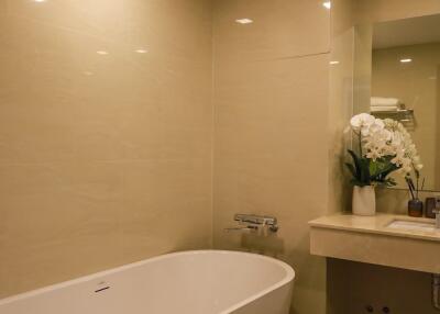 Modern bathroom with a bathtub, sink, and decorative elements