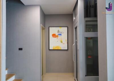 Modern hallway with artwork and elevator