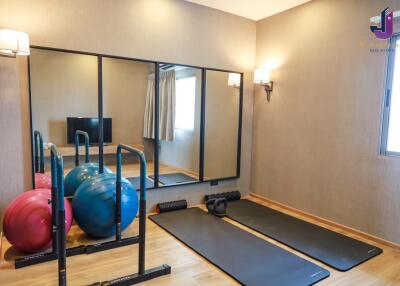 Home gym with exercise equipment and large wall mirrors