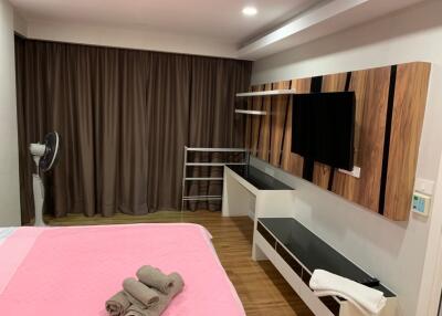 Modern bedroom with TV and shelving