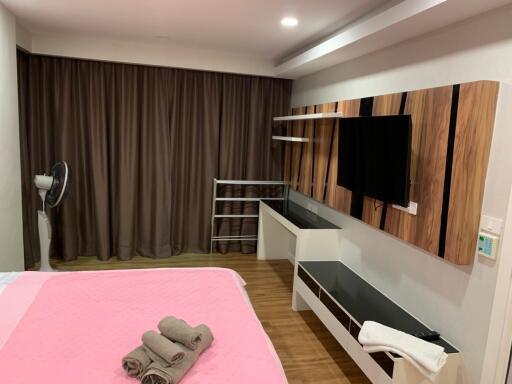 Modern bedroom with TV and shelving