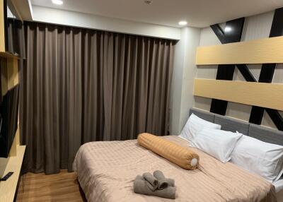 Cozy bedroom with a double bed, modern decor, and curtains