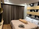 Cozy bedroom with a double bed, modern decor, and curtains