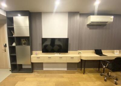Modern living room with TV, air conditioner, desk and storage unit