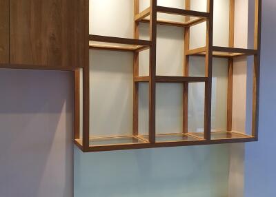 Wall-mounted wooden shelves with built-in lighting