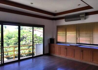 Spacious living room with large windows and built-in cabinetry