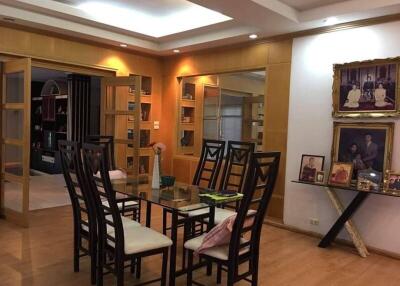 Elegant dining room with glass table and framed artwork