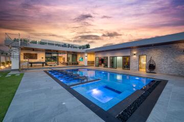 Modern luxurious outdoor pool area at sunset