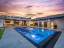 Modern luxurious outdoor pool area at sunset