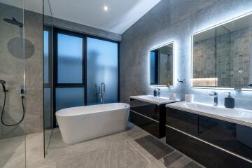 Modern bathroom with bathtub and double sink vanity