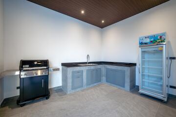 Modern kitchen with grill and refrigerator