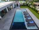 Modern outdoor swimming pool with lounge chairs