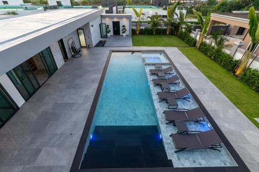 Modern outdoor swimming pool with lounge chairs