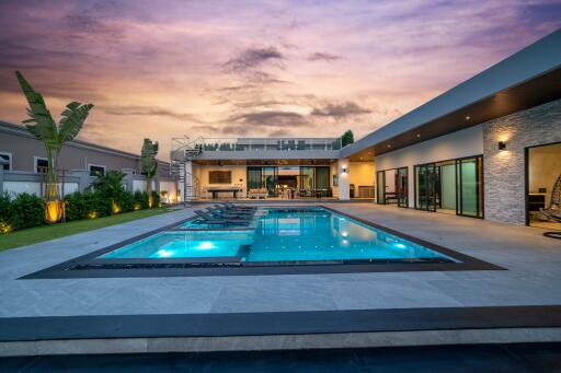 Modern backyard with a pool at sunset