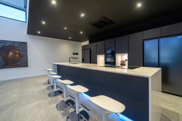 Modern kitchen with a sleek island and bar stools