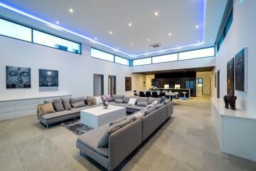 Modern living room with large sectional sofa and open kitchen