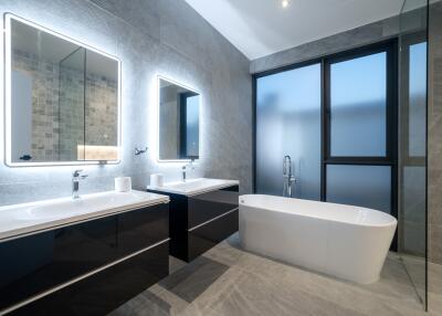 Modern bathroom with twin mirrors and freestanding bathtub
