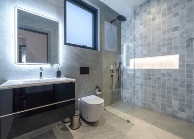 Modern bathroom with glass shower and wall-mounted sink
