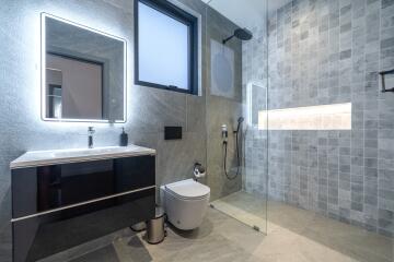 Modern bathroom with glass shower and wall-mounted sink