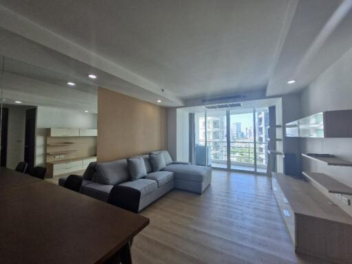 Modern, well-lit living room with furniture and large windows