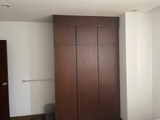 Bedroom with built-in wooden closet