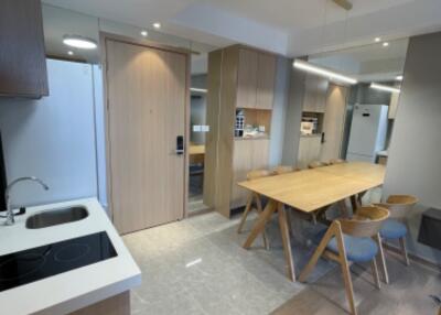 Modern kitchen and dining area with wooden furniture and ample lighting