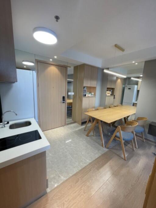 Modern kitchen and dining area with wooden furniture and ample lighting