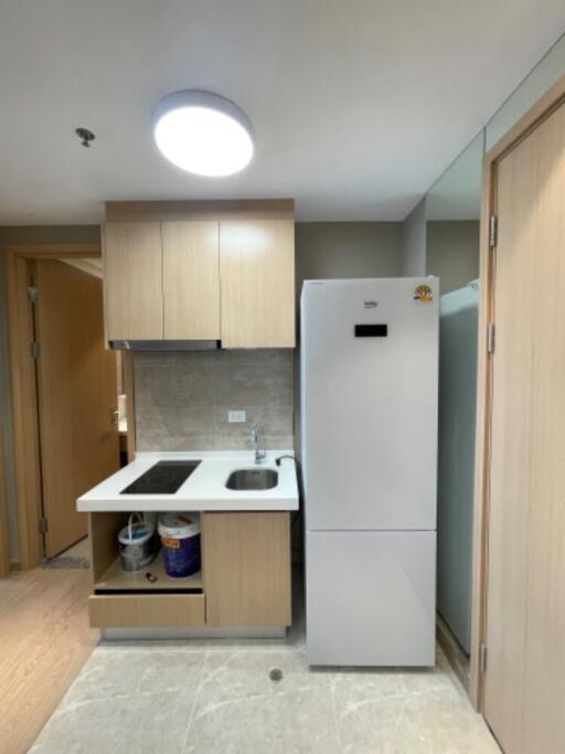 Modern kitchen with fridge, sink, and stove