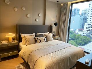 Modern bedroom with large window and city view