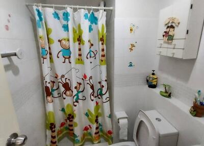 Bathroom with colorful shower curtain and white fixtures