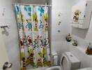 Bathroom with colorful shower curtain and white fixtures