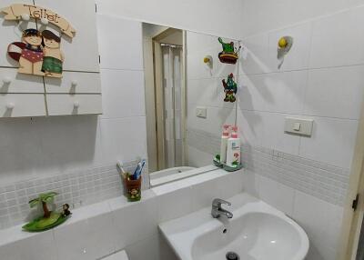 Small bathroom with sink, toilet, and mirror