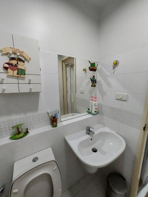 Small bathroom with sink, toilet, and mirror