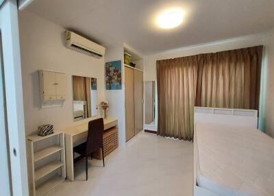 Spacious bedroom with study area and ample storage