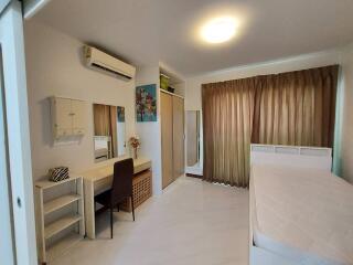 Spacious bedroom with study area and ample storage