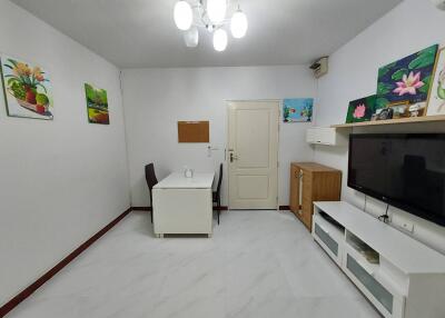 Modern living room with dining table and flat-screen TV