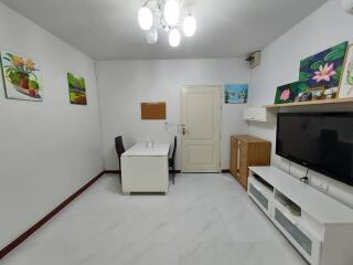 Modern living room with dining table and flat-screen TV