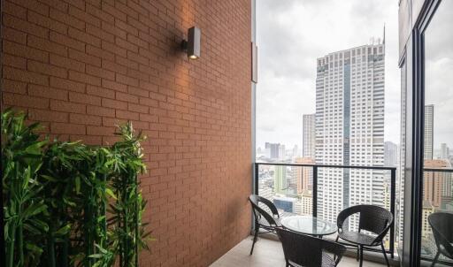 A city view balcony with a table and chairs