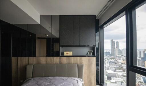 Modern bedroom with large windows and city view